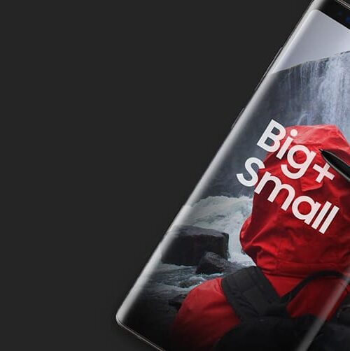 Person in red jacket with "Bight Small" text on tablet screen showing waterfall background