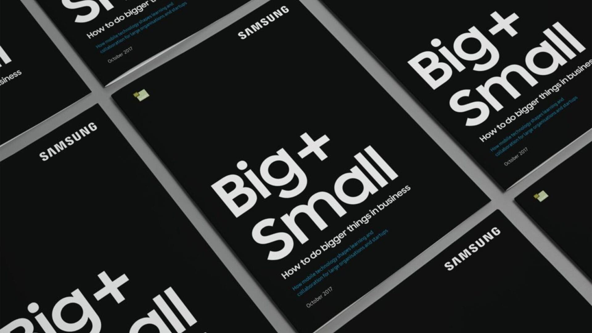 A collection of booklets on a dark surface, each featuring the title "Big + Small" in bold white text, along with the subtitle "How to do bigger things in business." The Samsung logo is prominently displayed on the top left of each booklet