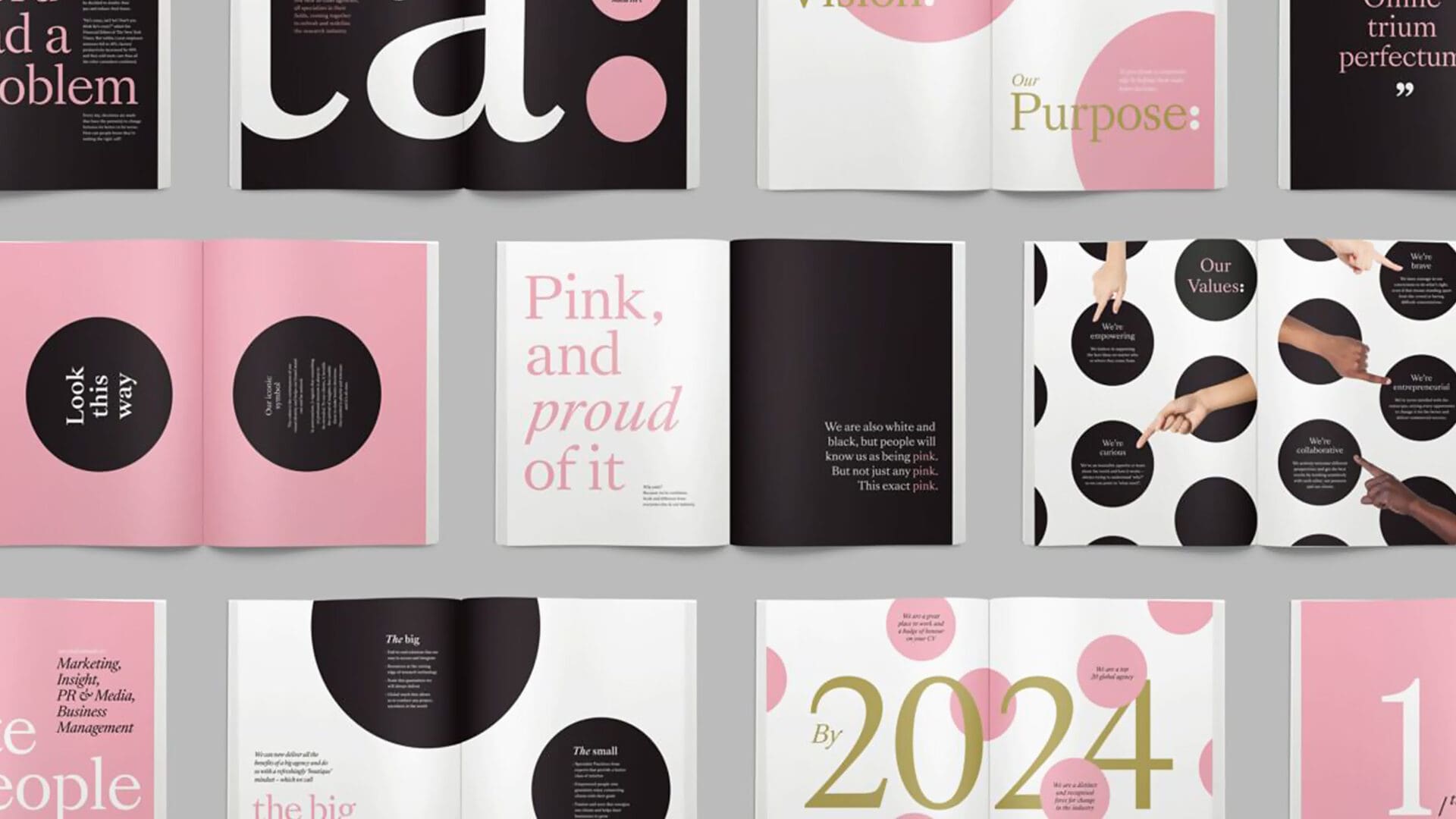 A flat lay of a magazine featuring various pages with bold typography and graphic elements. Highlights include phrases such as "Look this way," "Pink, and proud of it," and "Our Values:" along with descriptions of values like "We're empowering," "