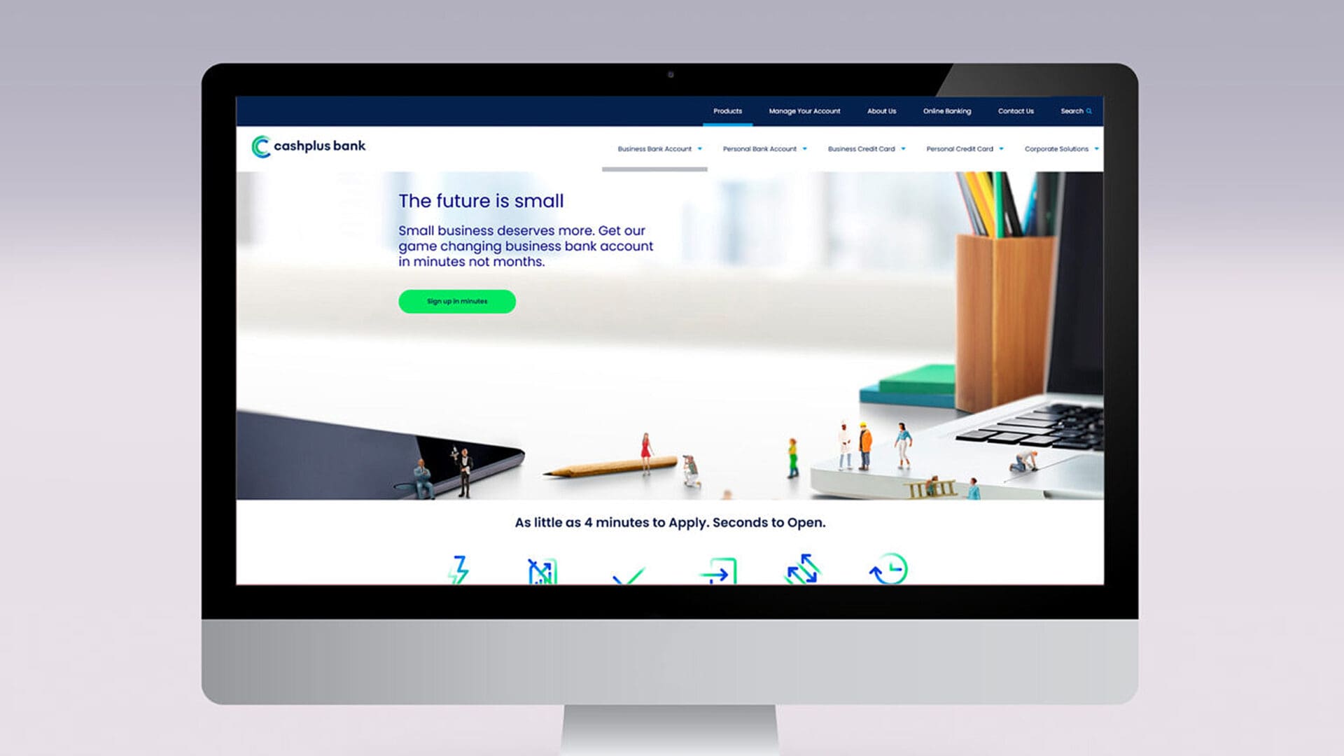 A computer screen displays a website for cashplus bank. The heading reads, "The future is small," followed by the text, "Small business deserves more. Get our game changing business bank account in minutes not months." There is a green button labeled